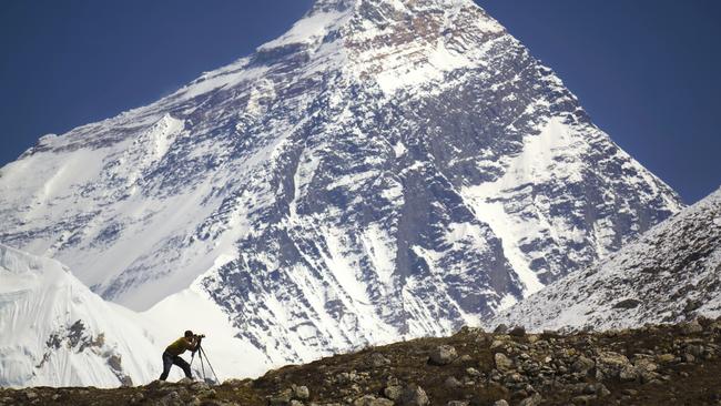 ESCAPE: WHEN TO BOOK NEPAL .. Mercedes Maguire story .. A man is standing in front of Mt. Everest. Nepal, Everest region (Sagarmatha National Park), Everest (8,850 m). Picture: iStock