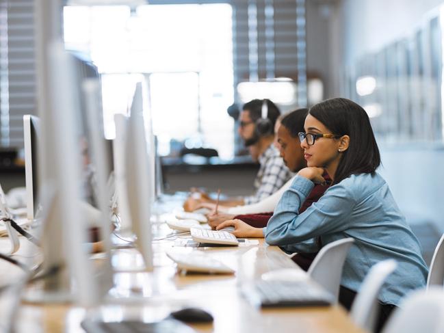 Shot of a group of university students working on computers in the library at campus