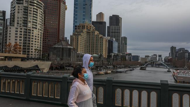 Pedestrians wearing masks cross the Yarra River on the weekend. Picture: Asanka Ratnayake/Getty Images