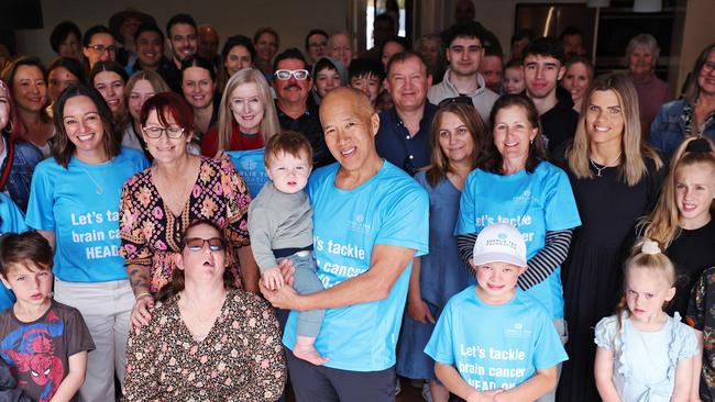 Former patients, family, friends and supporters of brain surgeon Charlie Teo (holding grandson Max) rallying before they walk across the Harbour Bridge. Picture: Sam Ruttyn