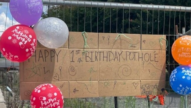 The gaping hole on Maudsley Street, Goomeri is closed off to vehicles and was decorated with decorated with birthday balloons and a large birthday card.