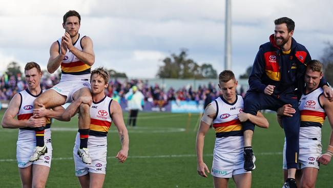 Richard Douglas and Andy Otten are chaired off after announcing their retirements from the Crows. Picture: AAP Image/Scott Barbour