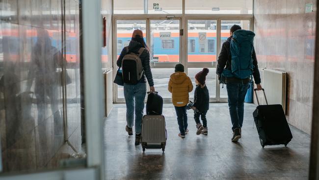 Family with two children at the train station