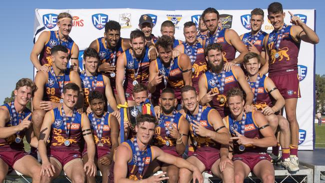 The Brisbane Lions NEAFL side celebrate their grand final win over the Southport Sharks.