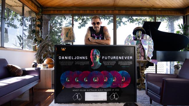 Daniel Johns, pictured at his home in Newcastle, NSW in September 2023 with a plaque to mark the ARIA chart success of his second solo album, FutureNever. Picture: BMG