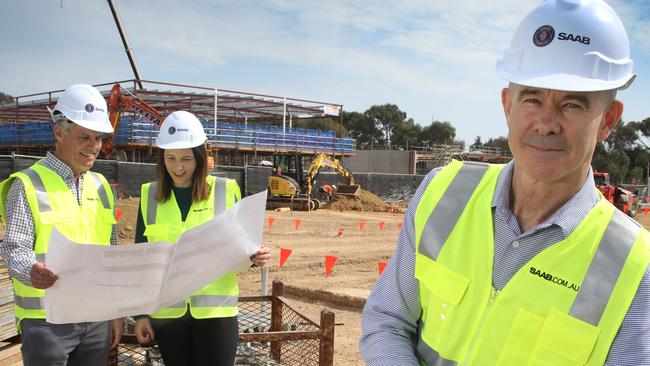 Defence and engineering firm Saab Australia, is constructing a new facility and growth pipeline. Managing director Andy Keough (F), with Head of Autonomous Systems, SAAB Australia, Rebecca Brickhill, and Dave Symonds, General Manager of the Maritime division of SAAB Australia, at the Mawson Lakes construction site. 18 September, 2023. Picture Dean Martin