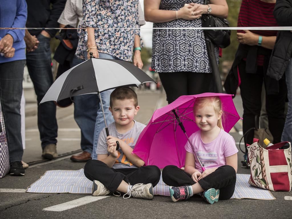 Siblings William, 5, and Sian, 4, wait for dad to march past in the Anzac Day parade. Picture: Mike Burton