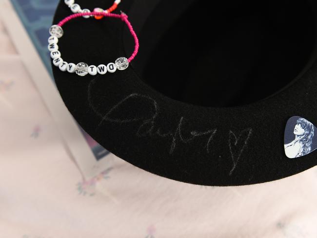 The signed hat, guitar pick and friendship bracelet Taylor Swift gave nine-year-old fan Milana Bruno at her MCG concert. Picture: David Smith