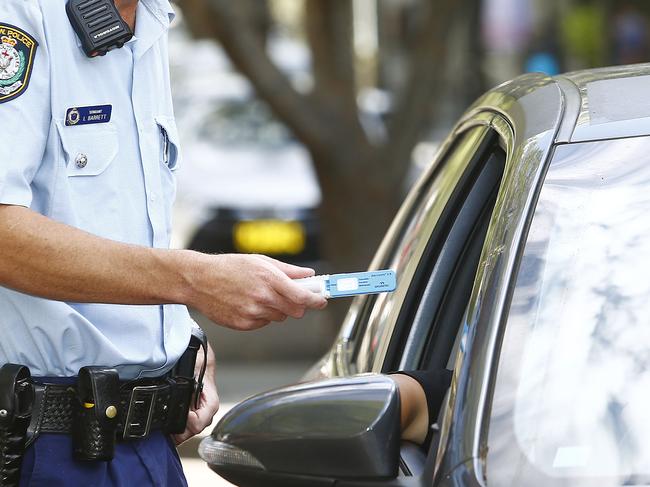 Eastern Suburbs  Police Area Command Traffic Supervisor Sergeant   Luke Barrett , simulates pulling over a driver for a Mobile Drug test  in Double Bay.  Police now have the Mobile drug test kits including the Drugwipe that quickly tests for the presence of Cannabis, Meth and cocaine. (Photo set up simulated using plain clothes police officer.)  Picture: John Appleyard