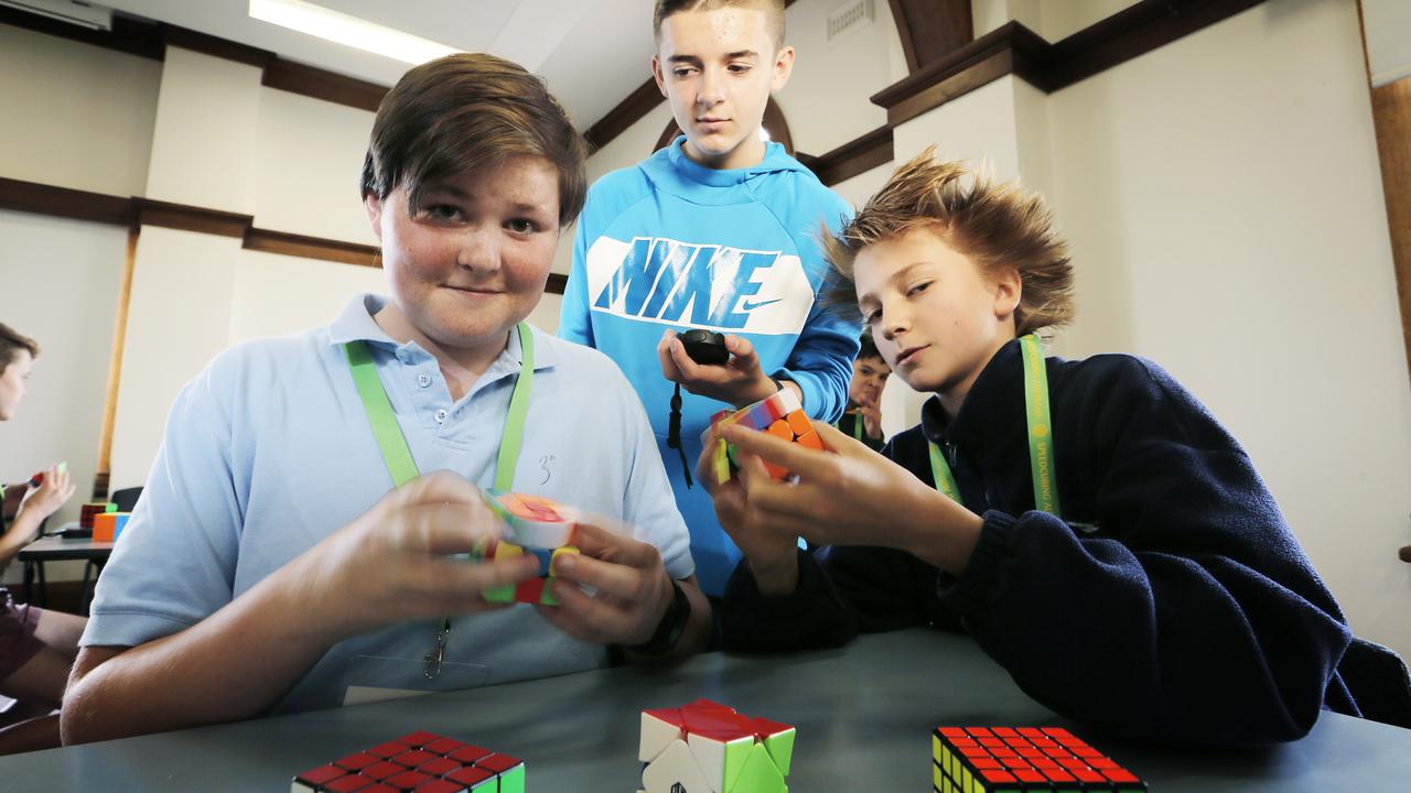 George Pelham times Jody Jones, 14, left, and Paddy Eldershaw, 12, on the 3x3 cube at the Hobart Open 2019 Speed Cube Championships in Tasmania in March. Picture: Mathew Farrell