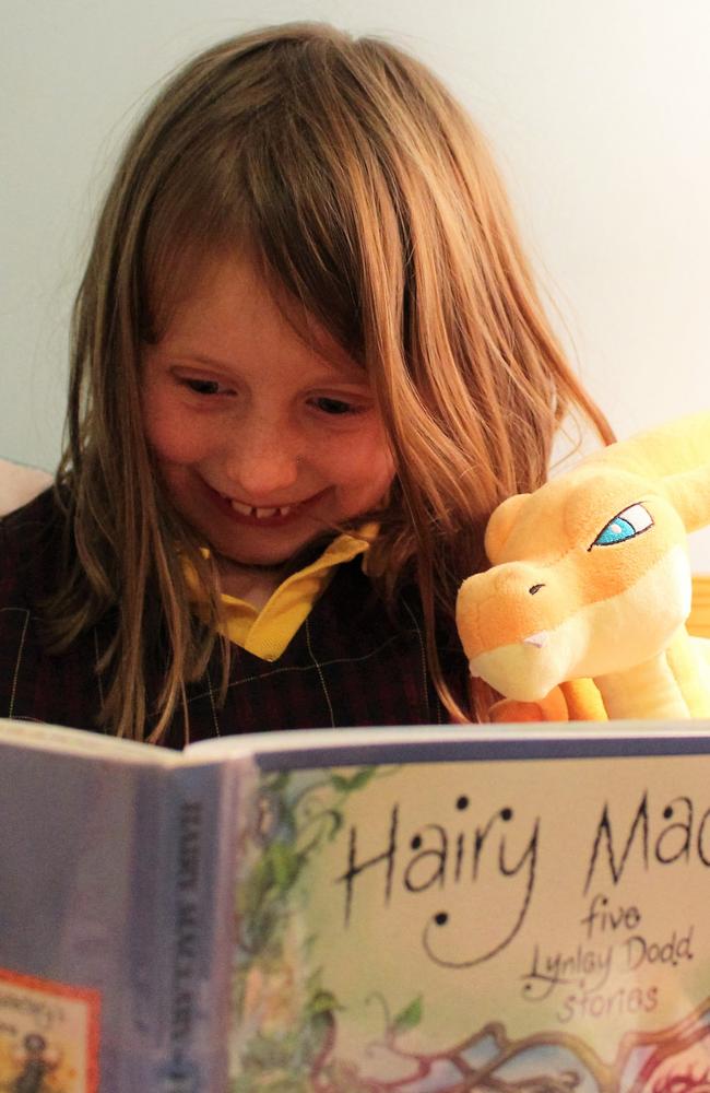 Ashleigh, 7, reads a Hairy Maclary for the Premiers' reading Challenge.