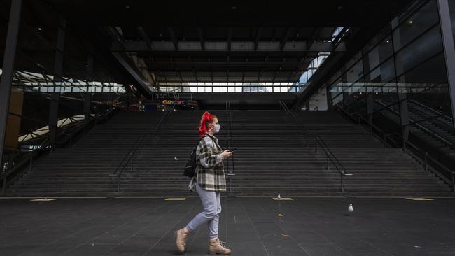 A Melburnian walks past a deserted Southern Cross Station on Monday. Picture: Daniel Pockett