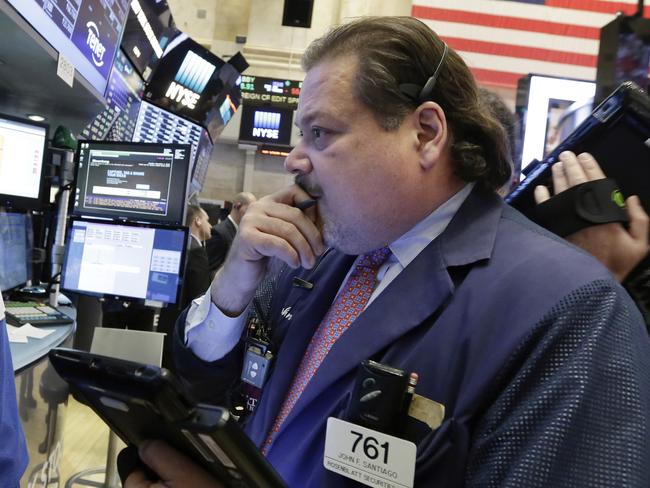 Trader John Santiago works on the floor of the New York Stock Exchange, Tuesday, Nov. 1, 2016. Stocks were flat to slightly lower on Tuesday as nervous investors continued to monitor the run-up to the 2016 election and wait for news from the Federal Reserve, which concludes a two-day policy meeting on Wednesday. (AP Photo/Richard Drew)