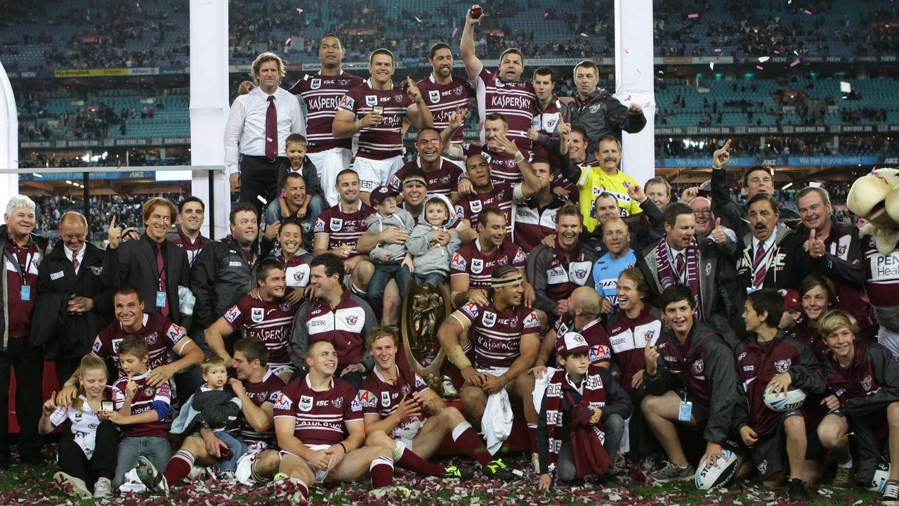 John Novak (on the left in a suit) celebrates at NRL Grand Final 2011.