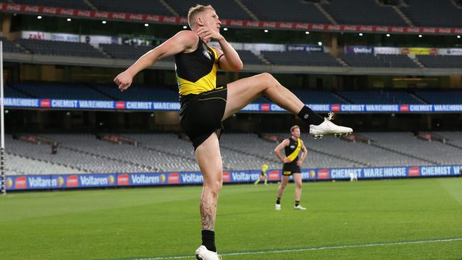 Josh Caddy of the Tigers kicks in front of empty stands ahead of Richmond’s clash against Collingwood. Picture: Michael Klein