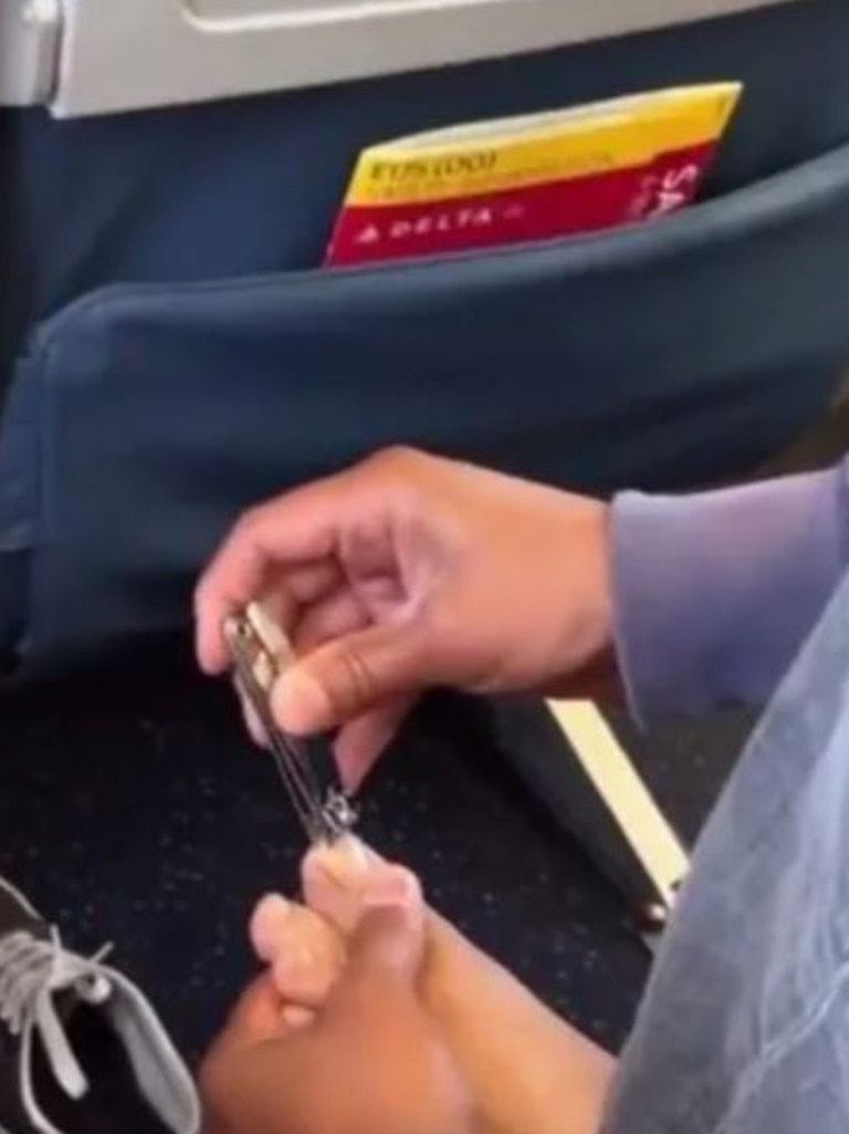 The man next to her was caught trimming his toenails