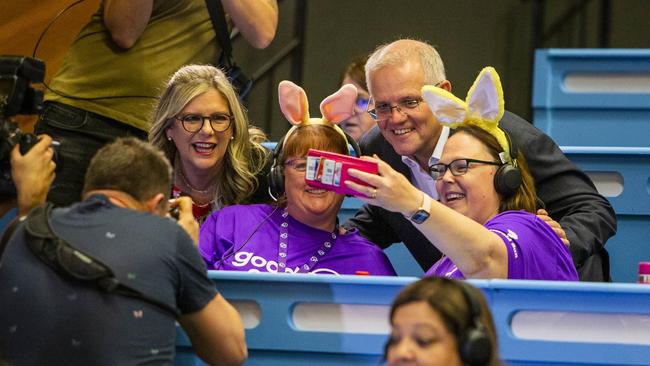 Prime Minister Scott Morrison with HWT chairman Penny Fowler has a selfie with volunteers in the telephone room during the 2022 Good Friday Appeal. Picture: Aaron Francis / Herald Sun