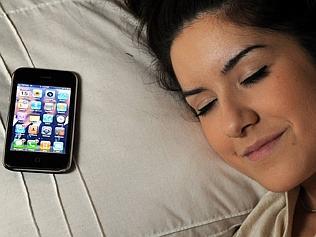 Kristy Pantaz, 16, with her mobile phone in bed. Teenage girls are so desperate to keep in touch with their friends 24/7 the...