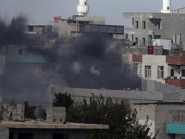 Smoke from a fire caused by an incoming mortar fired from the Syrian side, billows in Akcakale, Sanliurfa province, southeastern Turkey. Picture: AP