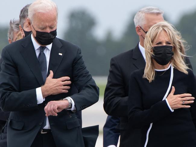 US President Joe Biden looks down alongside First Lady Jill Biden as they attend the dignified transfer of the remains of a fallen service member at Dover Air Force Base in Dover, Delaware. Picture: AFP