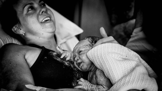 Hayley McBride holds her daughter moments after she was brought into the world. Photo: Angie Petersen, Desire to Inspire.​