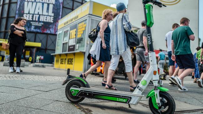 E-scooters from scooter-sharing company Lime are seen at Berlin's Checkpoint Charlie on June 23, 2019. (Photo by John MACDOUGALL / AFP)