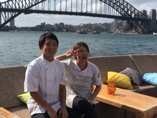 APIA Leichhardt star Tasuku Sekiya with a work colleague back at his job as a Sydney Opera House kitchen hand on Wednesday.