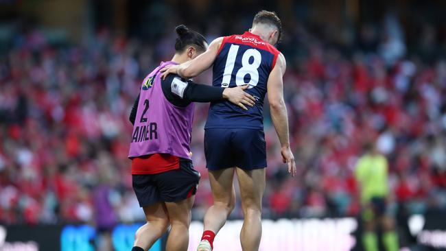 Jake Melksham is helped from the SCG on Sunday. Picture: Jason McCawley/AFL Photos/via Getty Images