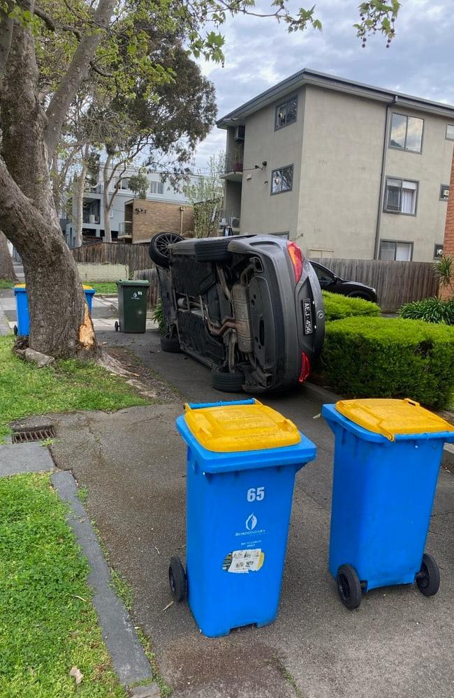 The BMW lays on its side after crashing in Hawthorn.