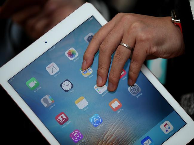CUPERTINO, CA - MARCH 21: An attendee looks at the new 9.7