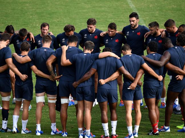 France's players huddle at the Suizenji Athletic Field in Kumamoto.