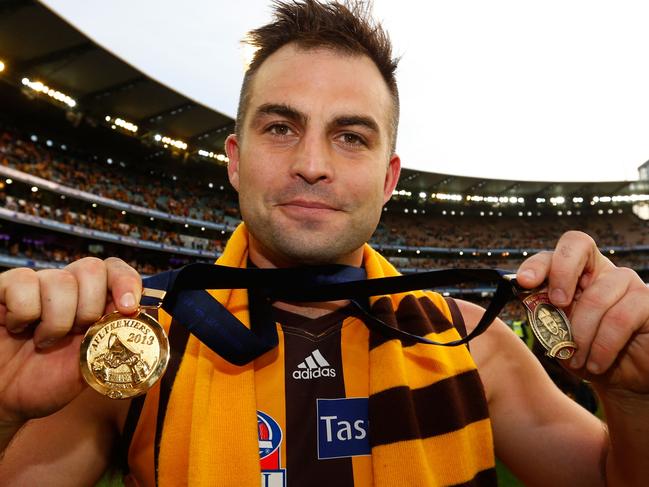 Embargoed until midnight Nov 13th.  Brian Lake of the Hawks poses for a photograph with his Norm Smith Medal and Premiership medal during the 2013 Toyota Grand Final match between the Hawthorn Hawks and the Fremantle Dockers at the MCG, Melbourne on September 28, 2013. (Photo: Michael Willson/AFL Media)