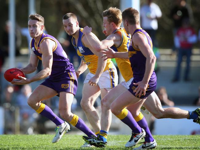 Ryan Mullett emerges from a pack with the footy during a previous stint at Vermont.