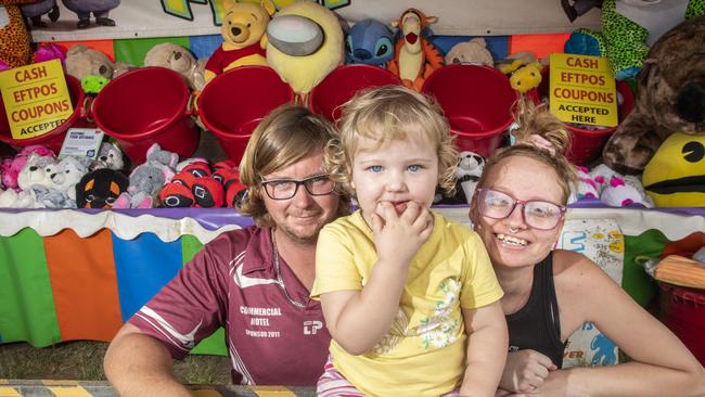 Isabelle Kampf 2yo tries out the family stand at the Toowoomba Royal Show with her parents Dallas Kampf and Jasmin Dewey. Thursday, March 24, 2022. Picture: Nev Madsen.