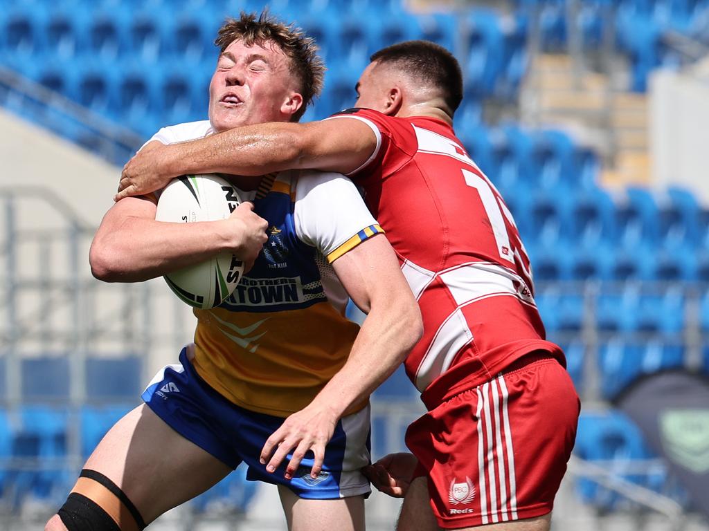 NRL National Schoolboys Cup final at CBUS Stadium between Palm Beach Currumbin and Patrician Blacktown Brothers. Patrician Blacktown Brothers Jhett Sydir hit high by PBCs Isaac Harrison. .Picture Glenn Hampson