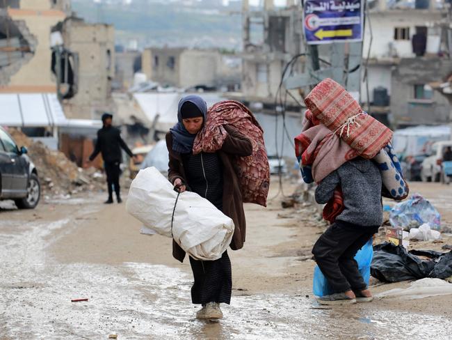 A Palestinian woman carries her belongings as she flees Beit Lahia in the northern Gaza Strip. Picture: AFP