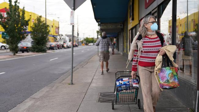 A woman walking home from the shops in Preston this morning. Picture: AAP Image/Stefan Postles