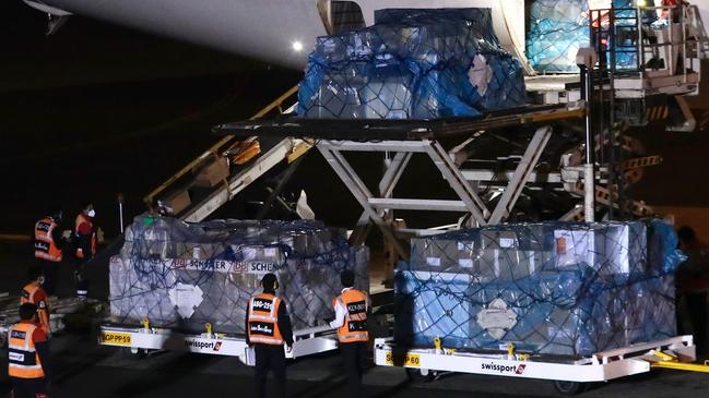 Peruvian workers unloading a first batch of 300,000 doses of Chinese Sinopharm laboratory vaccines in Lima. Picture: AFP