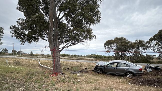 The wreck of the car showing the downed pole, after the crash at Waterloo Corner. Traffic has been diverted. Picture: Natalie Vikhrov