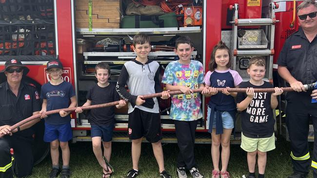 Firefighter Kenny Harrison, Ashton Smith, Riley Nash, Jarrah Robinson, Ryder Davies, McKenzie Robinson, Dexter Robinson and Firefighter Dean Wilson (left to right) pose in front of the Fire + Rescue NSW truck for the 120th Murwillumbah Show. Picture: David Bonaddio