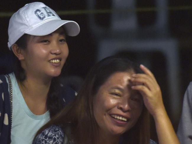 Family members celebrate while camping out near Than Luang cave following the news that the boys and coach had been found alive.