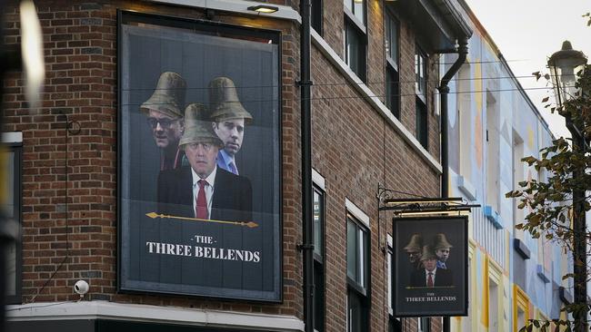 Britain's Prime Minister Boris Johnson, Britain's Health Secretary Matt Hancock and Number 10 special adviser Dominic Cummings, are pictured on a sign outside the James Atherton Pub in New Brighton' which has been renamed "The Three Bellends" in protest against new local lockdown measures. Picture: Christopher Furlong/Getty Images