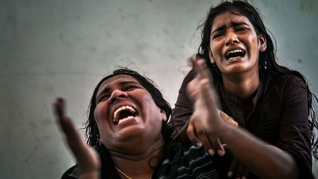 Two Sri Lankan female survivors grieve in Cidaun after an Australia-bound boat carrying asylum-seekers sank off the Indonesian coast, leaving many dead in 2013. Picture: Ardiles Rante/Hati Kecil 