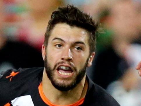 Tiger's James Tedesco makes a break during the game between the Wests Tigers and South Sydney Rabbitohs at ANZ Stadium.Homebush.Picture Gregg Porteous