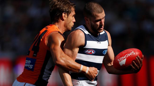 Matt De Boer puts the clamps on Geelong’s Sam Menegola on Saturday. Picture: Michael Willson/AFL Photos/Getty Images. 