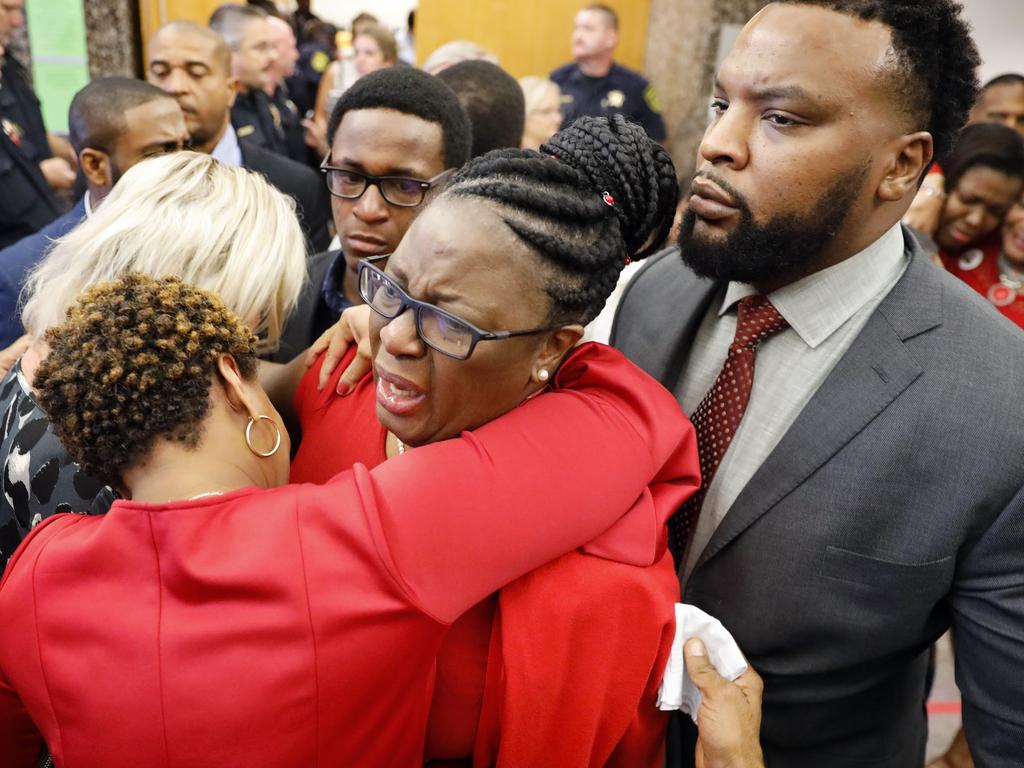 Botham Jean's mother, Allison Jean (centre) outside the courtroom after former Dallas police officer Amber Guyger was found guilty of murder. Pic: AP