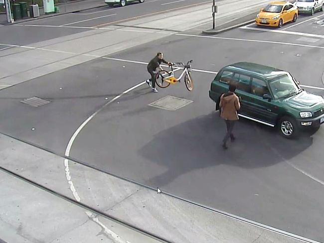 A man grabs an oBike and flings it at the rear of the car to try and stop its path of terror.