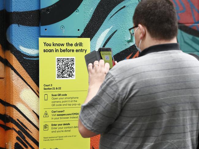 MELBOURNE, AUSTRALIA - FEBRUARY 08: A QR code is scanned by a spectator as they arrive on day one of the 2021 Australian Open at Melbourne Park on February 08, 2021 in Melbourne, Australia. (Photo by Darrian Traynor/Getty Images)