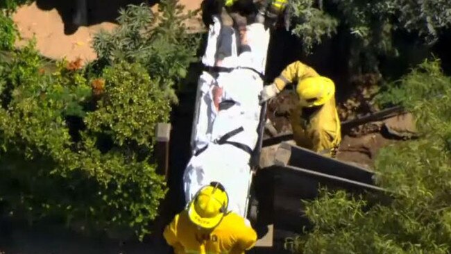 Heche is carried away in a stretcher following the fiery smash. Picture: Fox 11