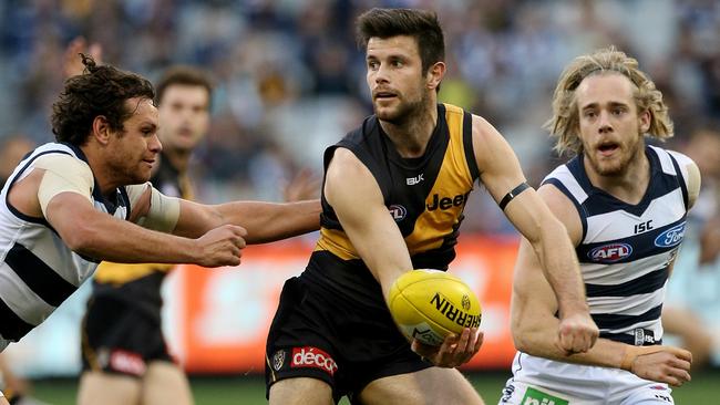 Trent Cotchin gets some much needed midfield assistance. Picture: Wayne Ludbey